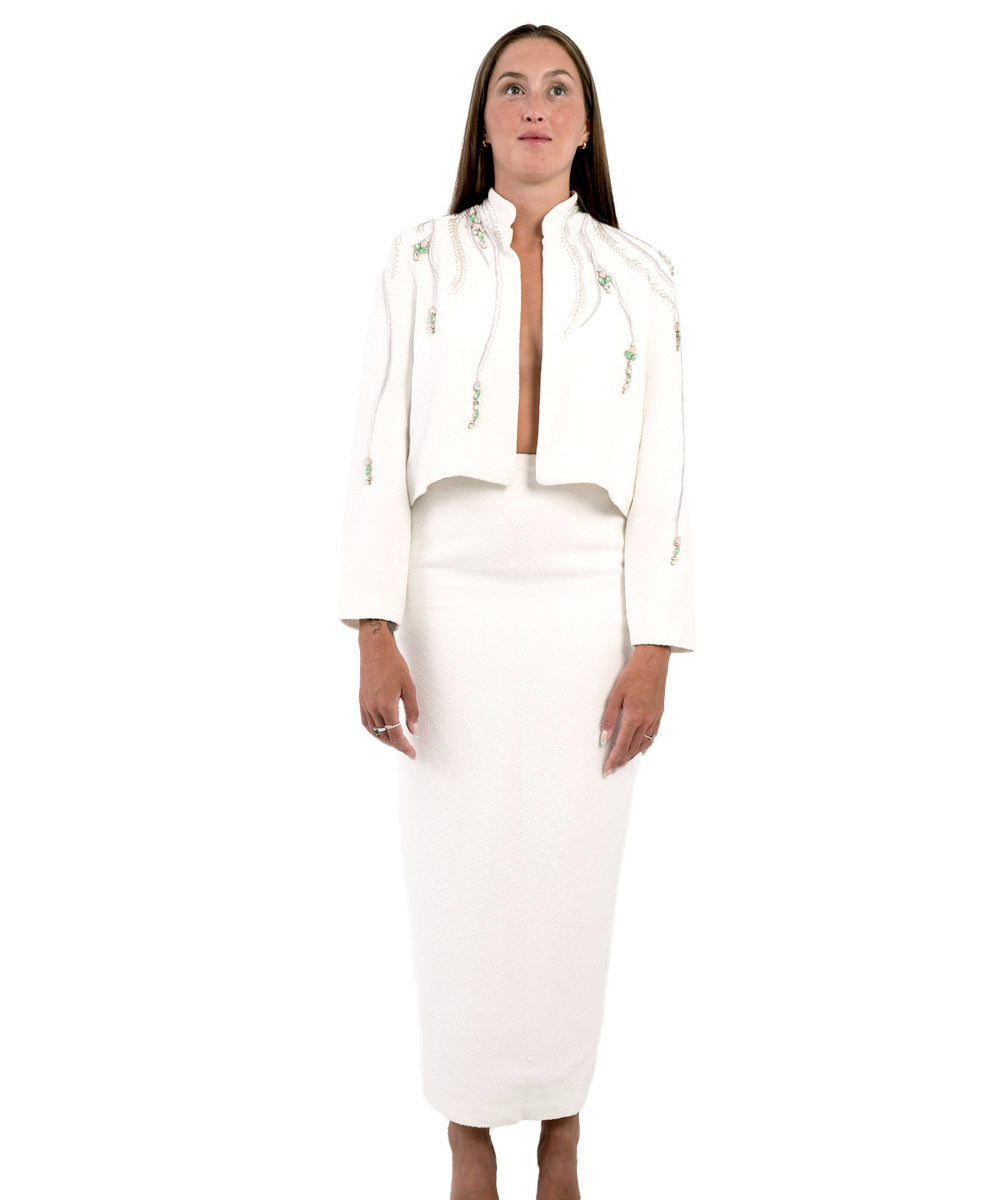 Sustainable Silk Pencil SkirtFits like a glove, feel like a bombshell. This ankle length pencil skirt is exactly what you have been waiting for. All white and ready to be paired with your favorite top and our hand beaded bolero jacket for a night out. Mad